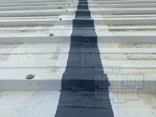 Completed corrosion treatment on metal roof showing seamless protective coating
